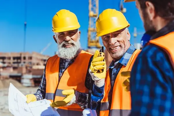 Workers wear yellow hard hats