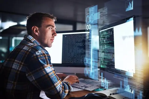 Man in plaid shirt works intently