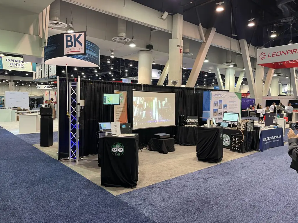 Black tablecloths cover booth furniture