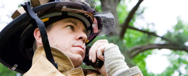 Firefighter wears protective helmet gear