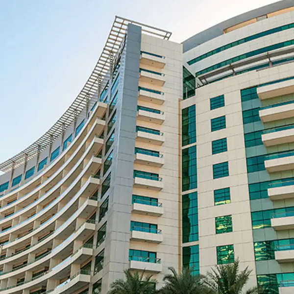 Curved beige building with balconies
