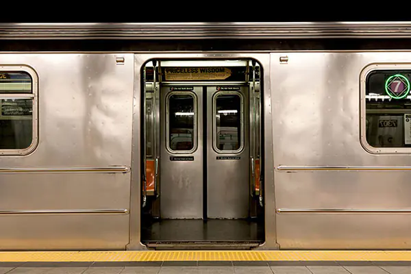 Silver subway train doors open wide